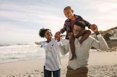 A happy family enjoys a beach vacation using HELOC funds.
